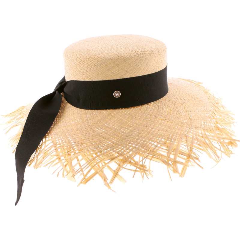 Large straw hat with ribbon and unstructured edge.