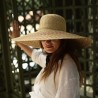 Women's hat with very wide straw brim, with interior drawstring.