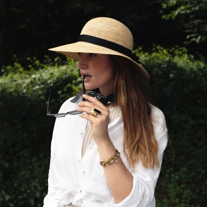 Large straw brim hat, with plain ribbon and interior drawstring.