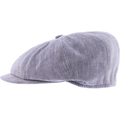 Newsboy cap in fabric with herringbone pattern.